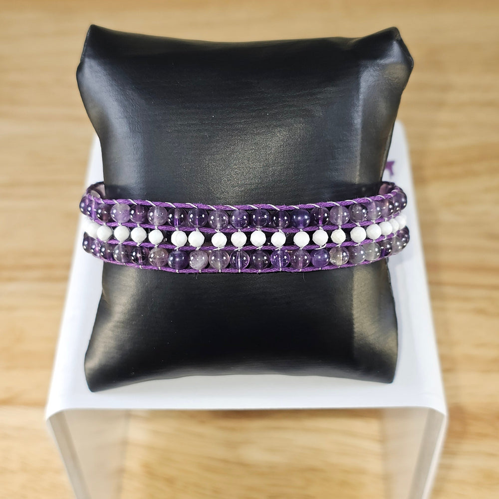 Made using Amethyst 4mm round bead and Howlite 3mm faceted round beads. This bracelet is handmade by Crave's Crystals using the following number of each bead.  Amethyst - 126 beads  Howlite - 32 beads  size: This bracelet can we worn snuggly by anyone. At its largest size this bracelet will fit males up to 8 inch size. At its smallest this bracelet closes to fit 6 3/4 inch size and can be worn by anyone with a wrist size from 6 3/4 inch to 8 inch.